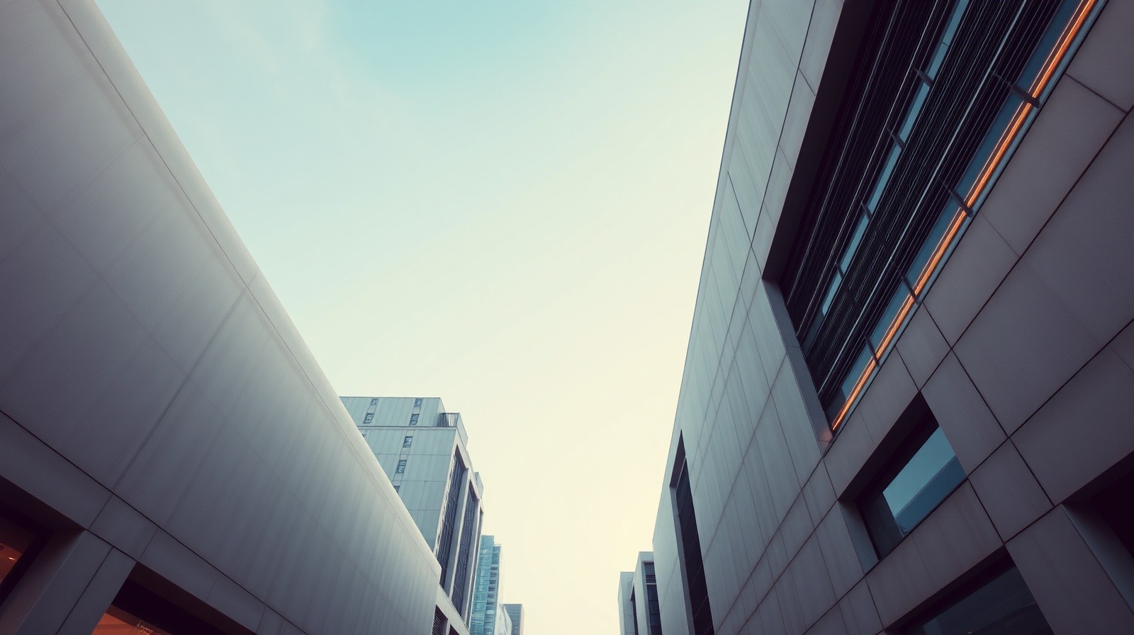 Two modernist Gangnam clinic buildings rising toward a warm blue-hour sky, a narrow band of light between them.